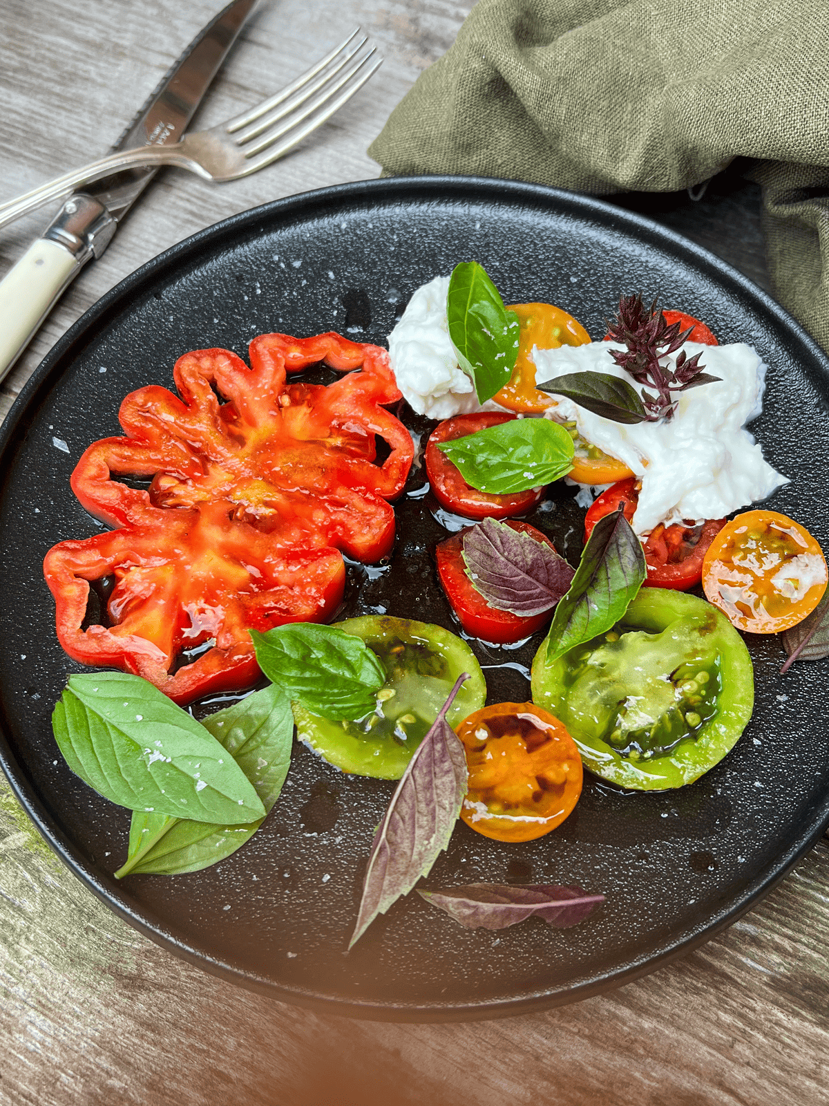 Tomato salad with scalloped tomato, green zebra, Sungold and Juliet tomatoes.