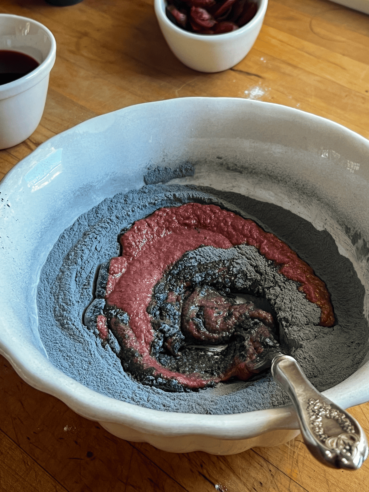 Mixing beets, charcoal, flour and other ingredients for making charcoal dog treats.