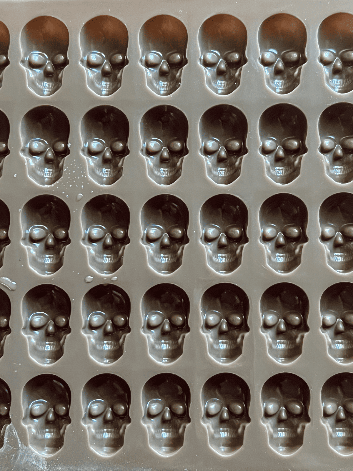 Skull shaped silicone mold for baking or freezing.