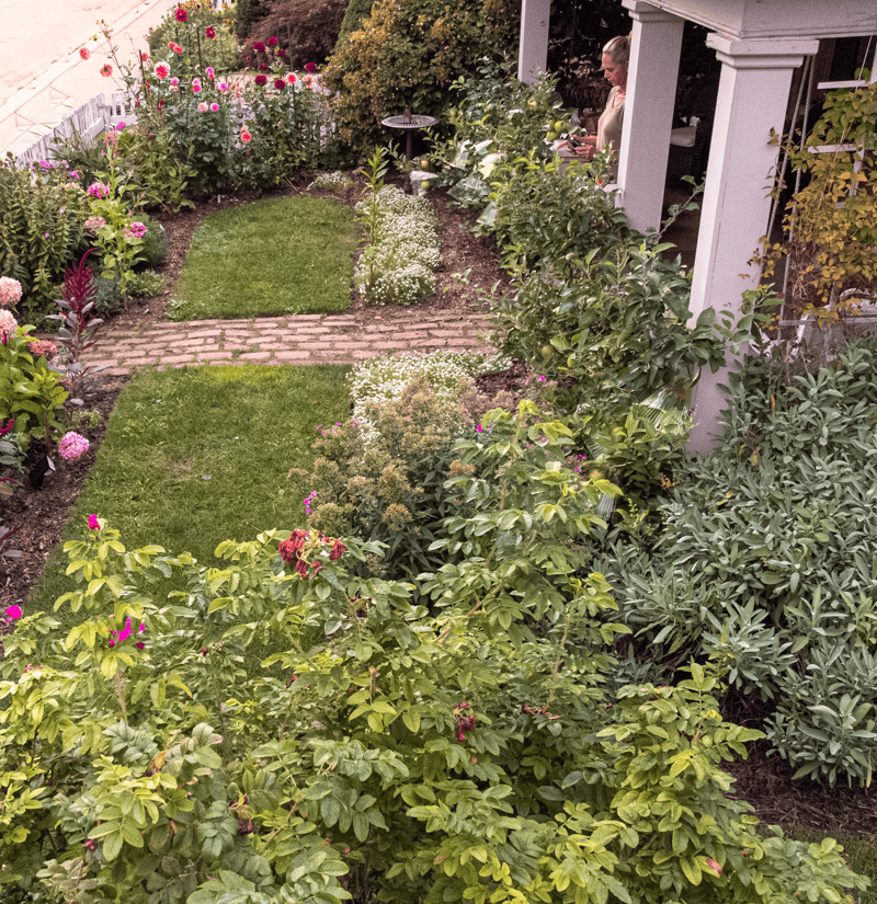 English cottage garden steps away from white front porch.