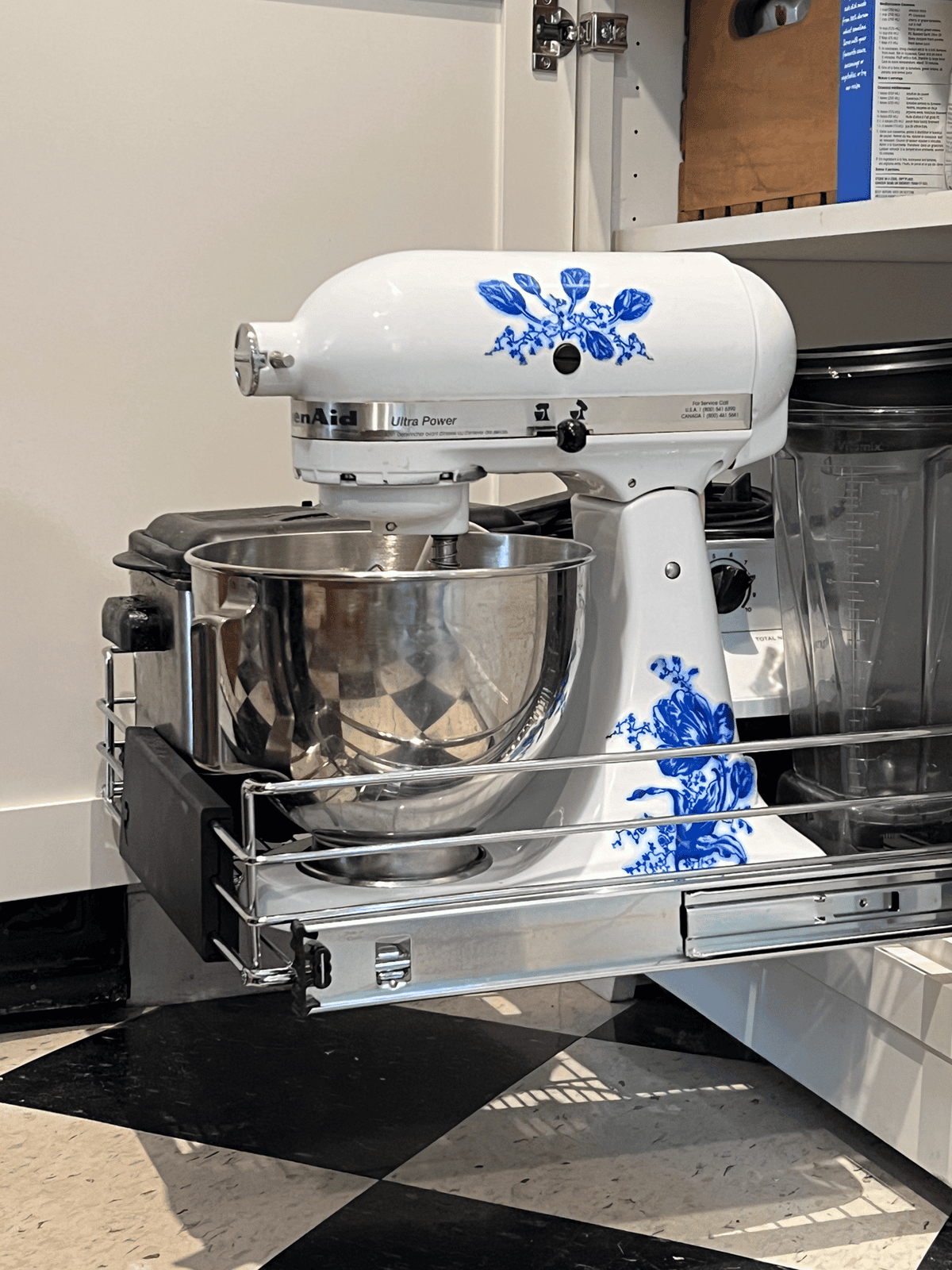 Pull out cabinet shelf with stand mixer and vitamix on it.