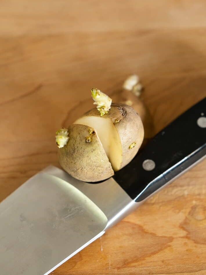 A seed potato cut in half with 3 eyes on each side.