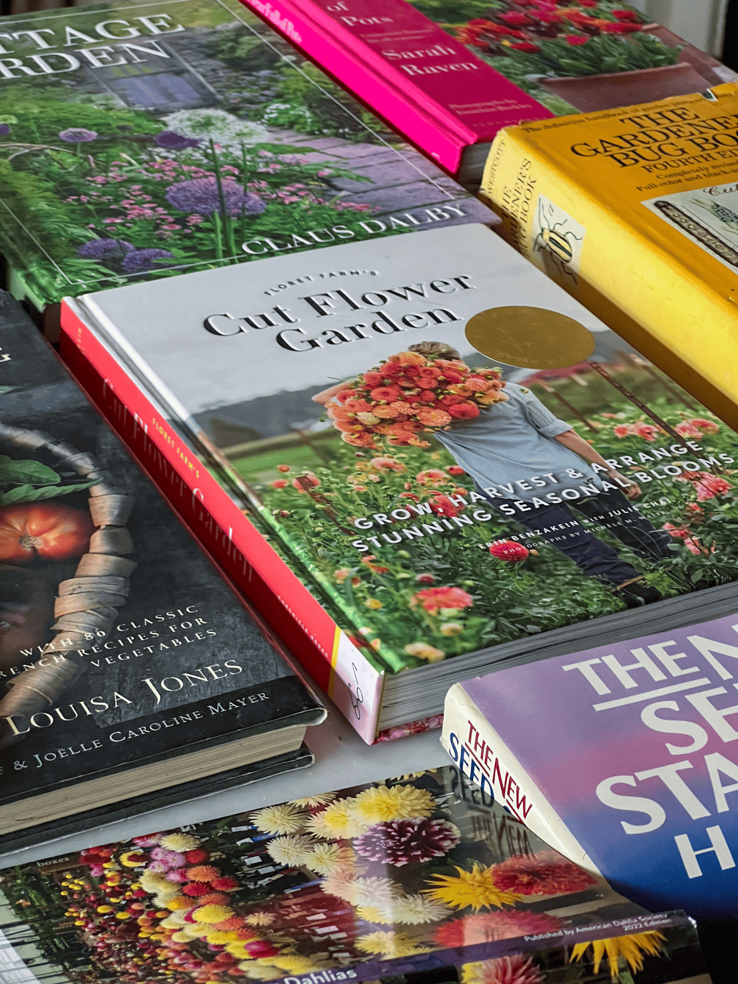 A stack of gardening books with Erin Benzakein's The Cut Flower Garden front and centre.