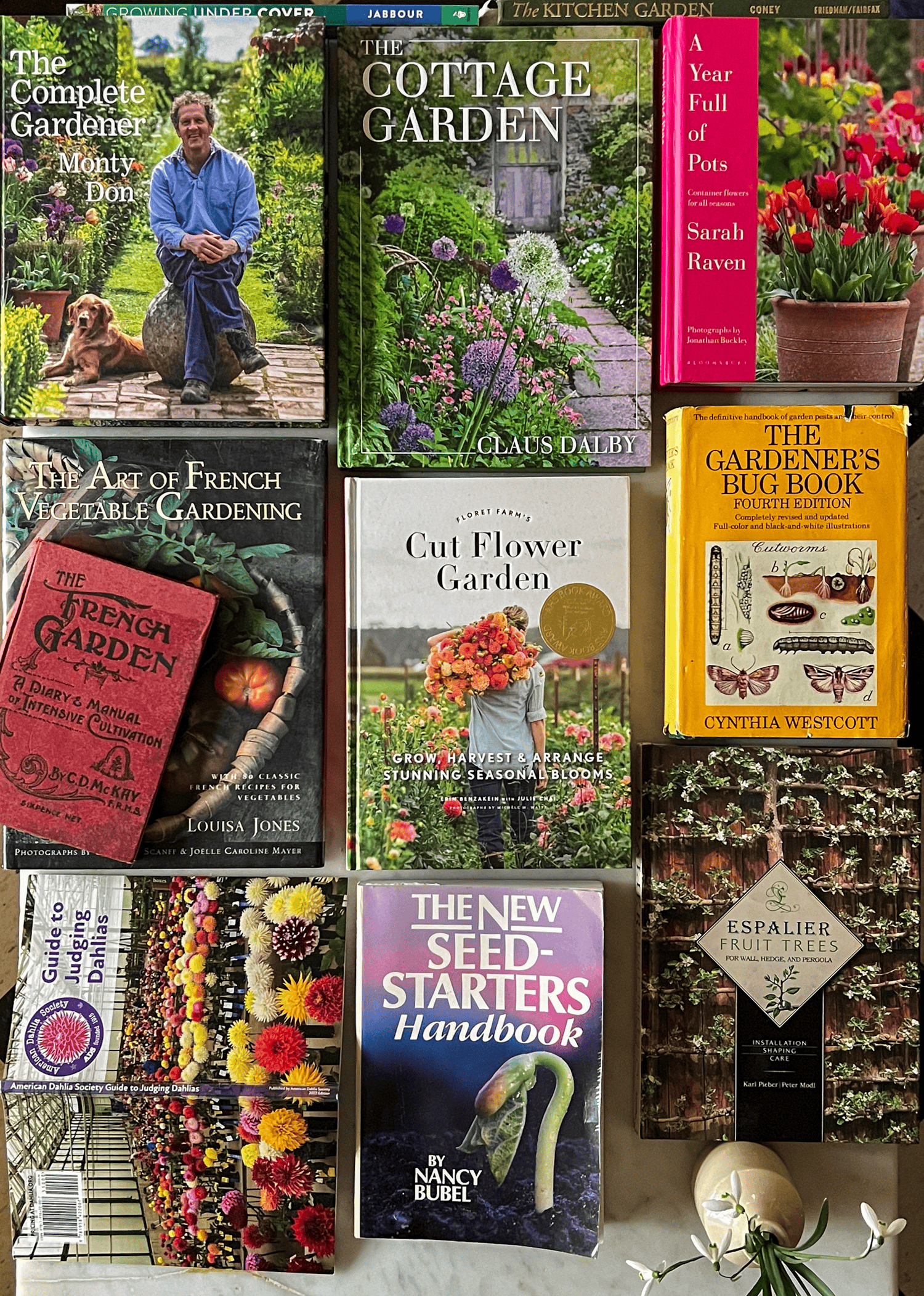 Karen Bertelsen's favourite gardening books to pull out for the season laid on a table including the Cut Flower Garden, New Seed Starters Handbook and more.