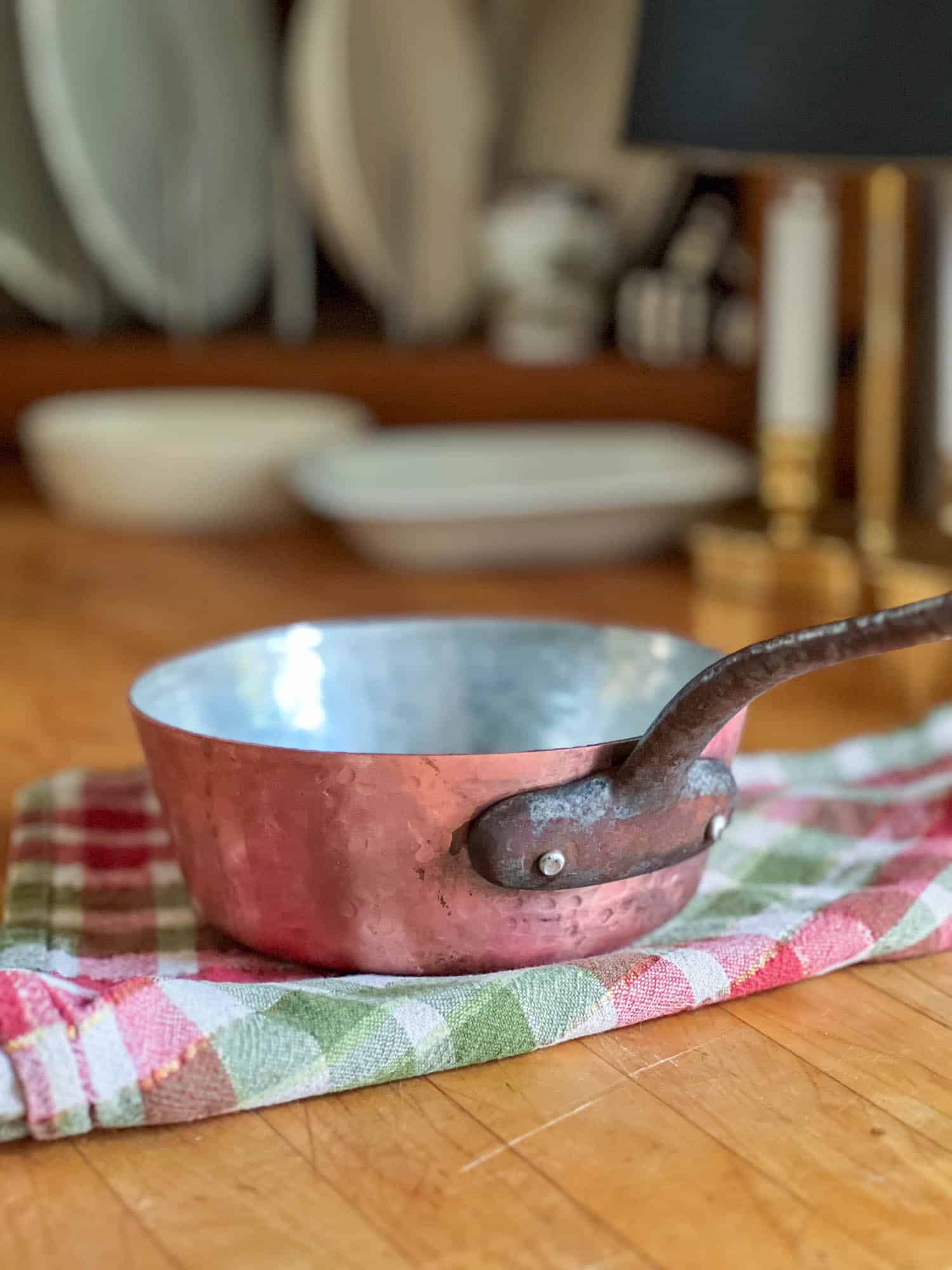 A copper pot post ketchup cleaning sits on the countertop.