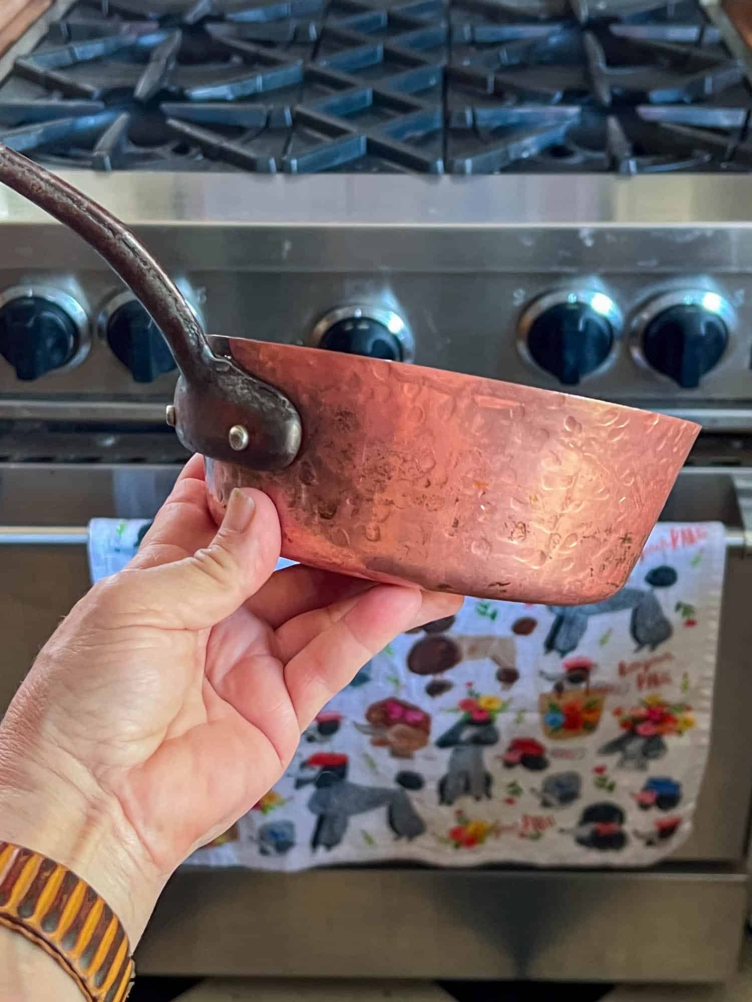A copper pot cleaned with ketchup leaves it clean, a little unevenly so, and a matte finish on the copper.
