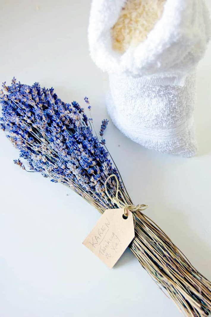 A bunch of lavender tied with string aside a terry towel bag filled with rice.