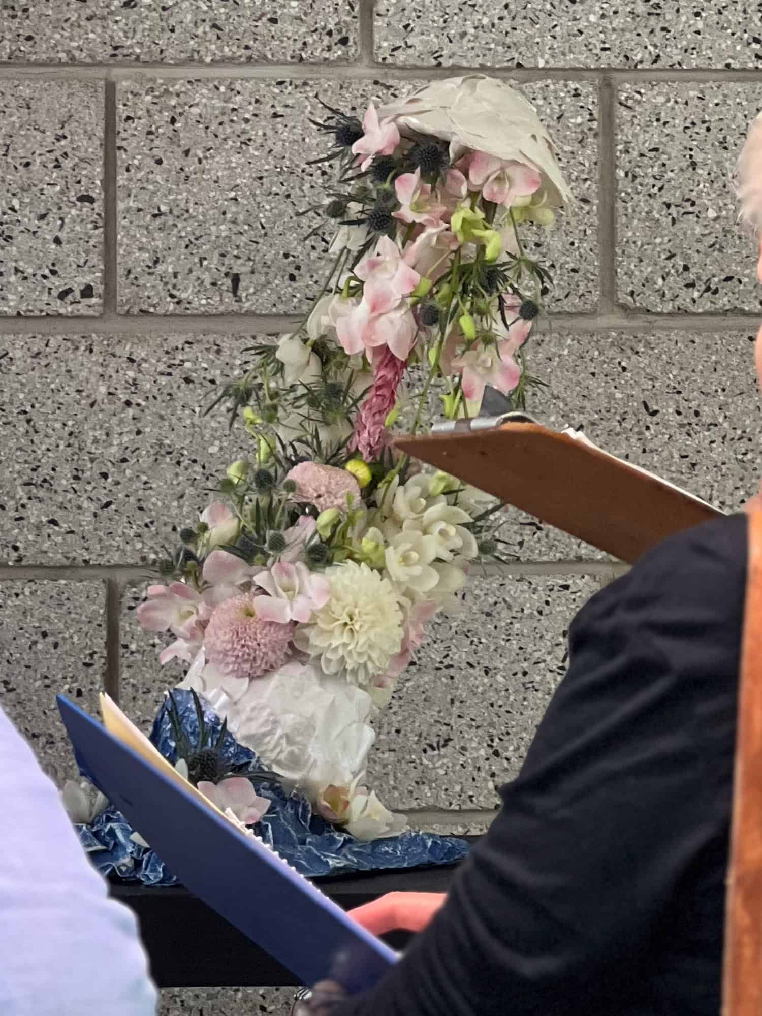 A pale pink and white floral arrangement that looks to be stretching.