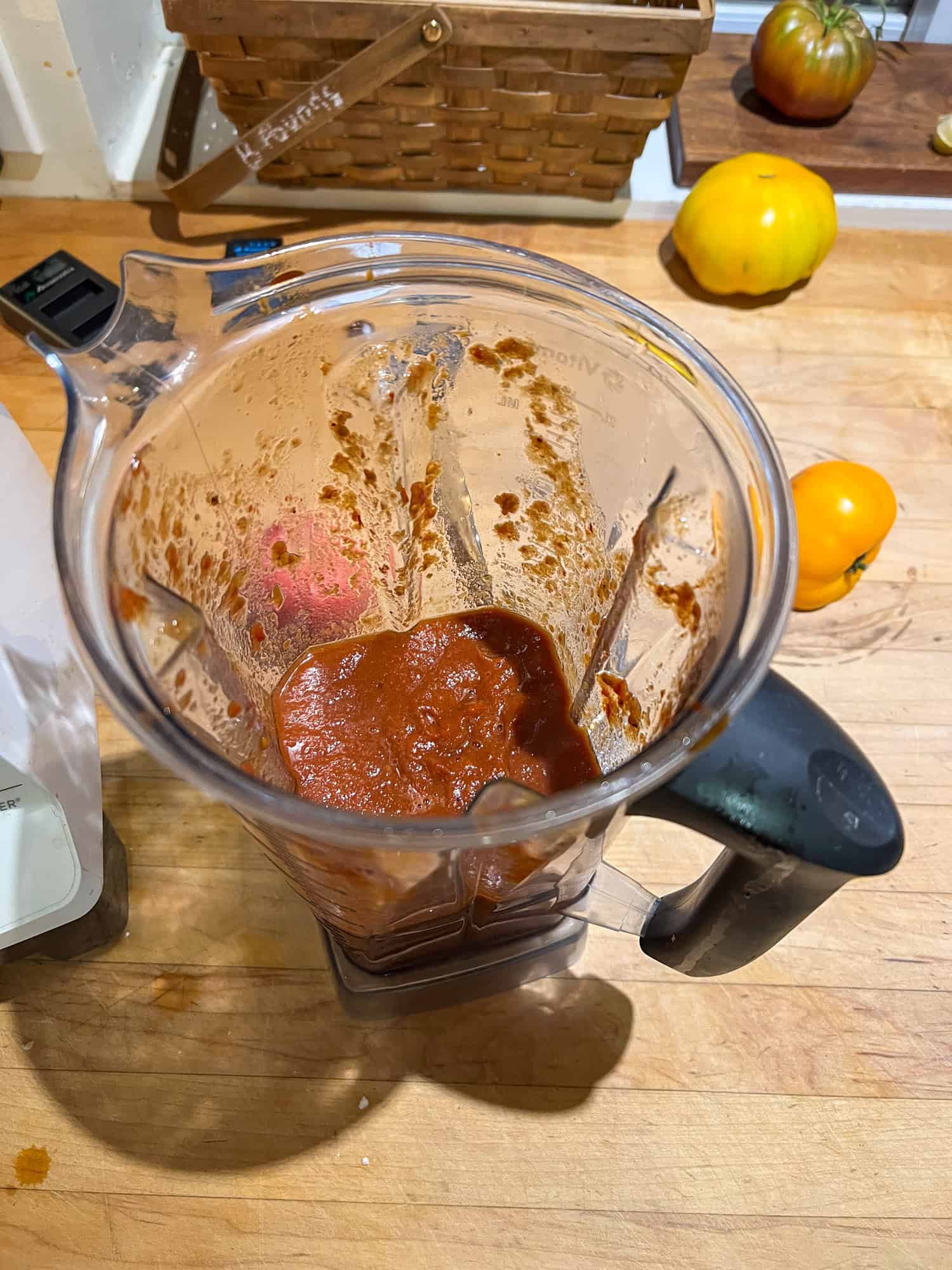A completely smooth tomato sauce made with roasted tomatoes inside a blender container.