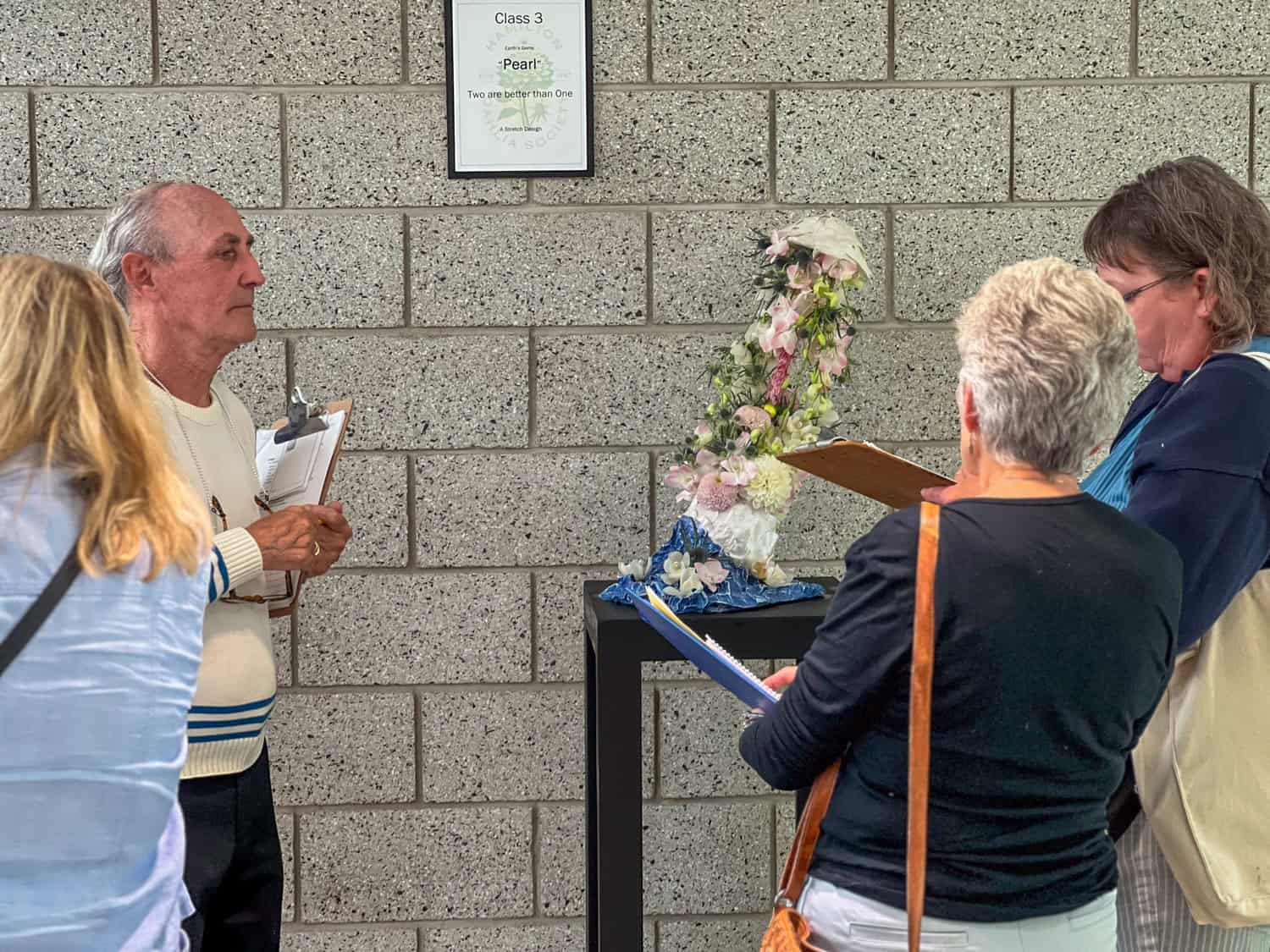 Judges assess a exhibition floral arrangement at the Hamilton Dahlia Society show.