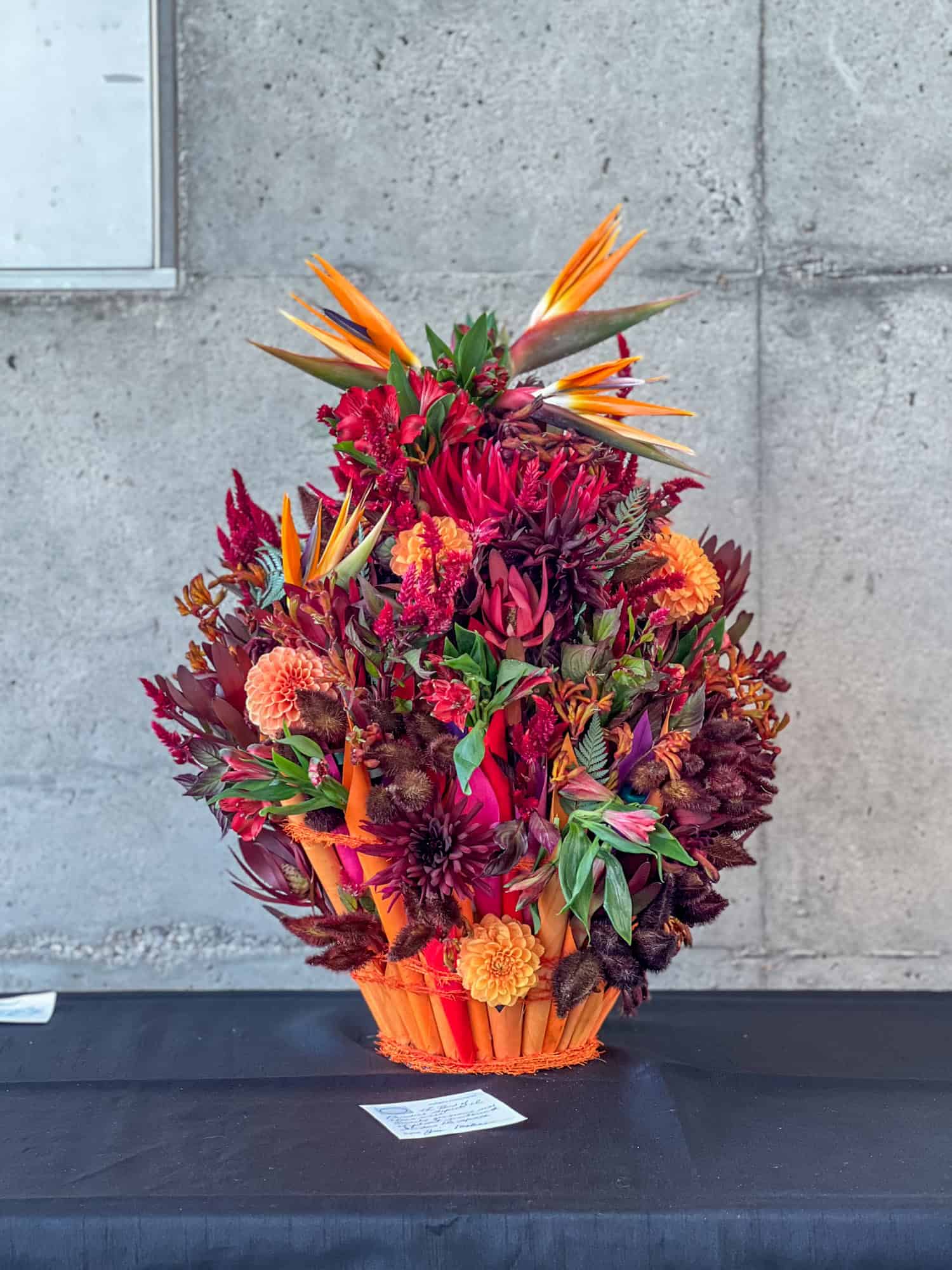 A tropical looking floral display in a basket for exhibition.