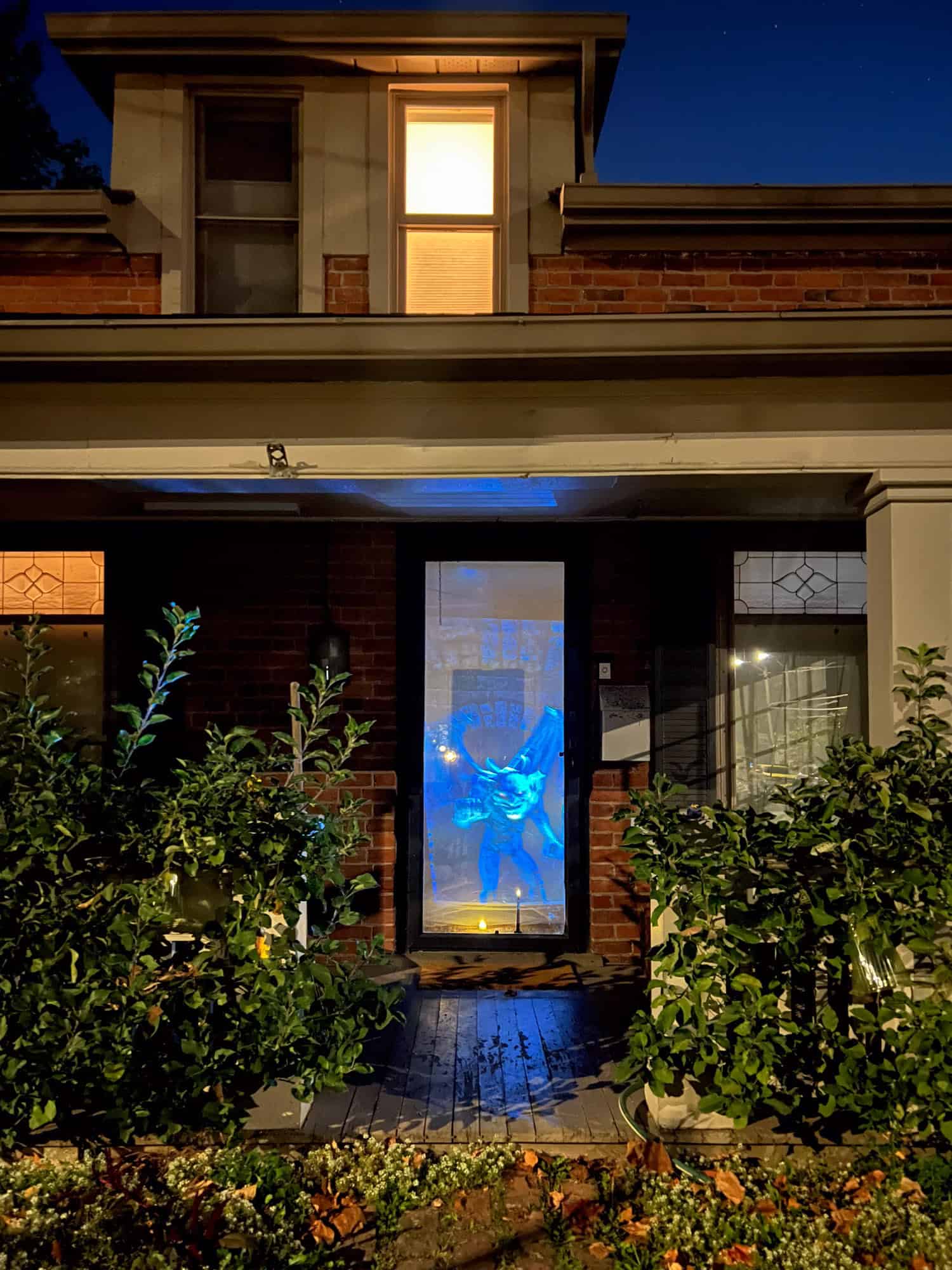 Vertical window projection in the front door of an old house.